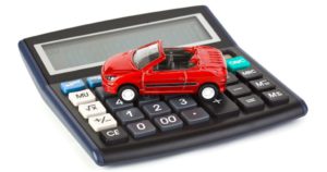 Calculator and toy car isolated on white background